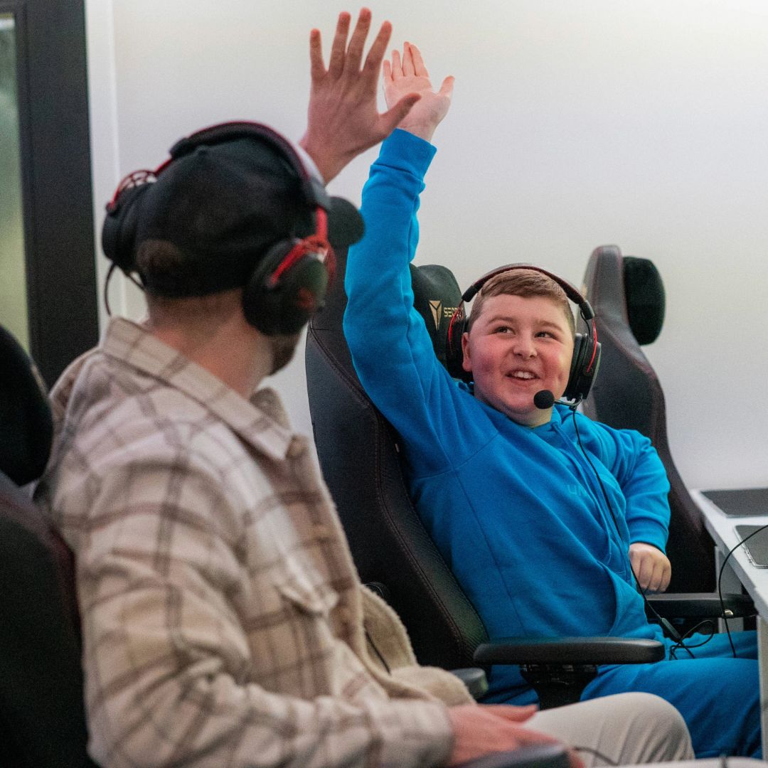 A Make-A-Wish child enjoying gaming with a headset